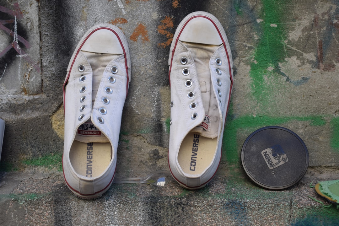 pair-of-white-converse-sneakers-with-unlaced-eyelets-rwujsslwqkk